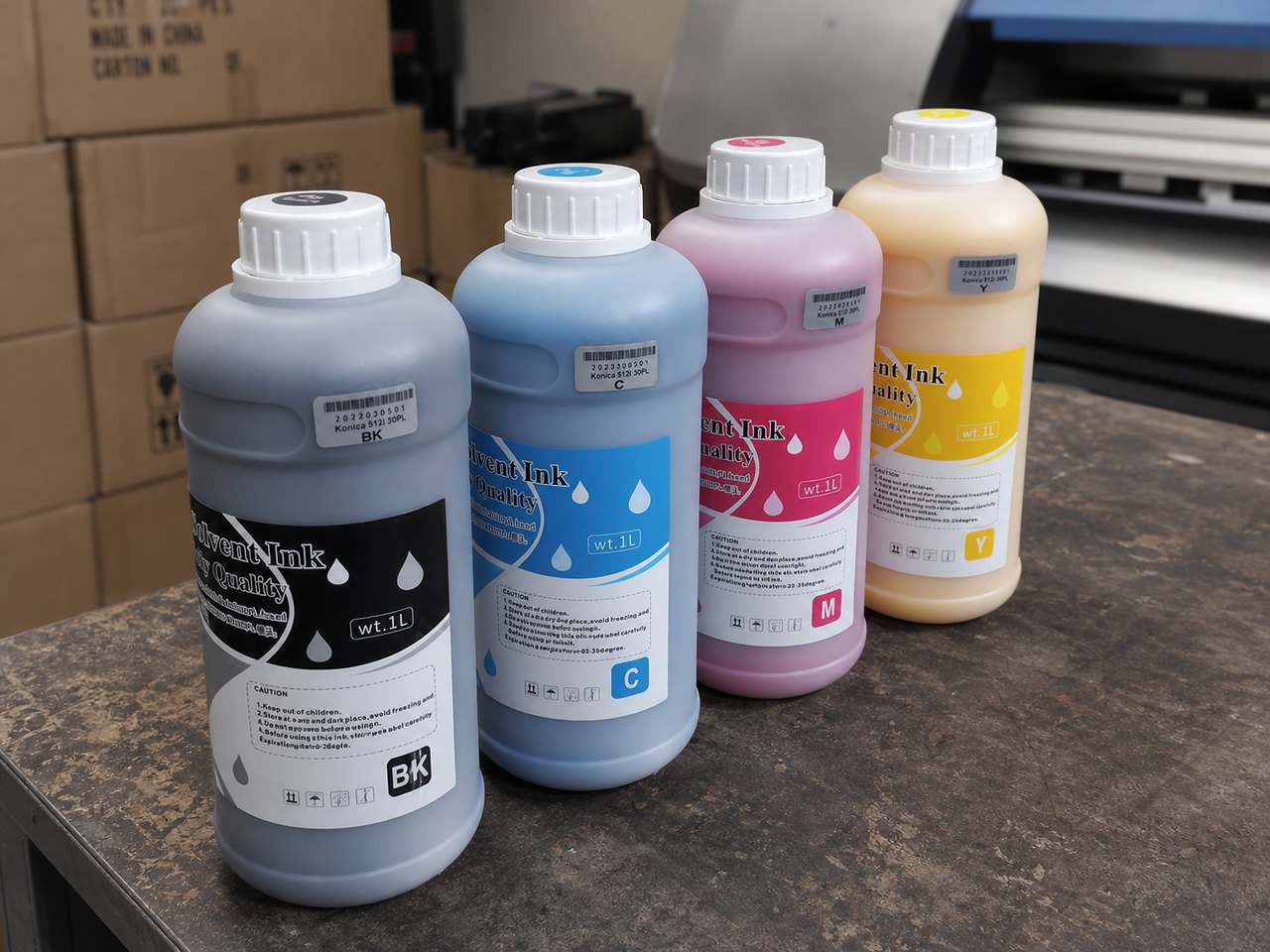 CMYK printing ink bottles arranged on a workshop table